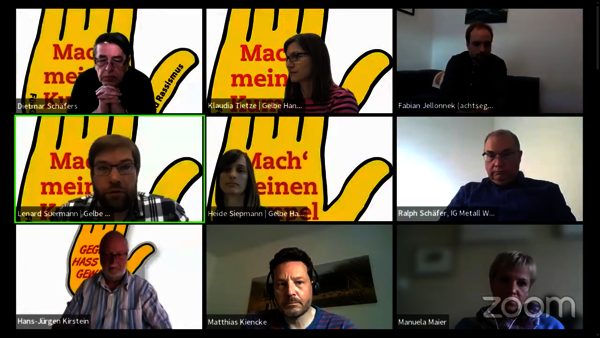 Ein Screenshot von einer Videokonferenz mit neun Personen, die per Videoübertragung zu sehen sind. Einige von ihnen haben das Gelbe-Hand-Logo als Hintergrundbild.